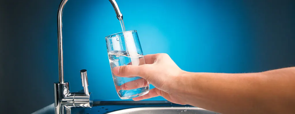 Clean drinking water from a purifier tap for Service Junction water purifier service in Mysuru